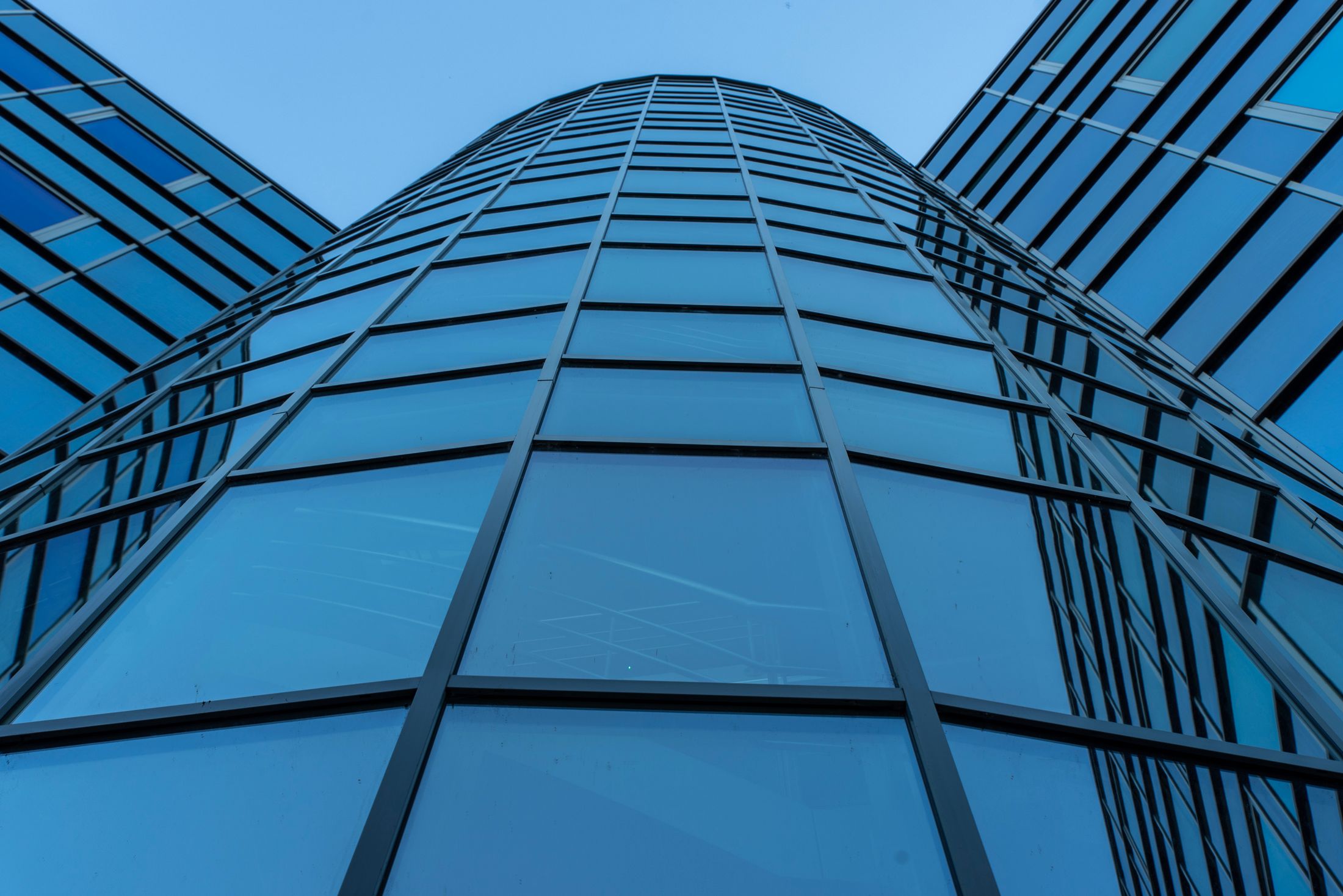 Upward view of a glass office facade.